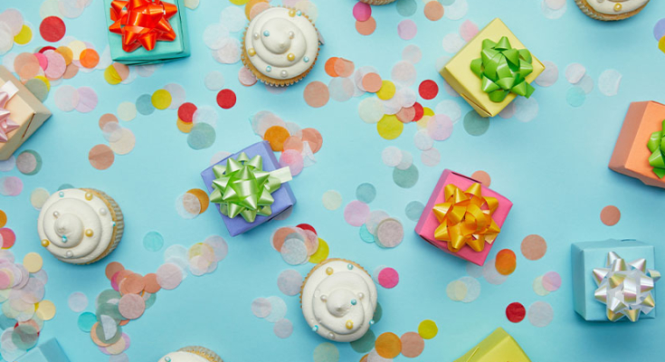 cupcakes, presents, and sequins on a blue background