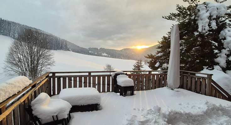 a wooden deck covered in snow