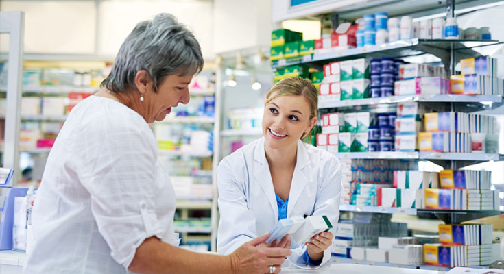Pharmacist showing a person medicines in a pharmacy