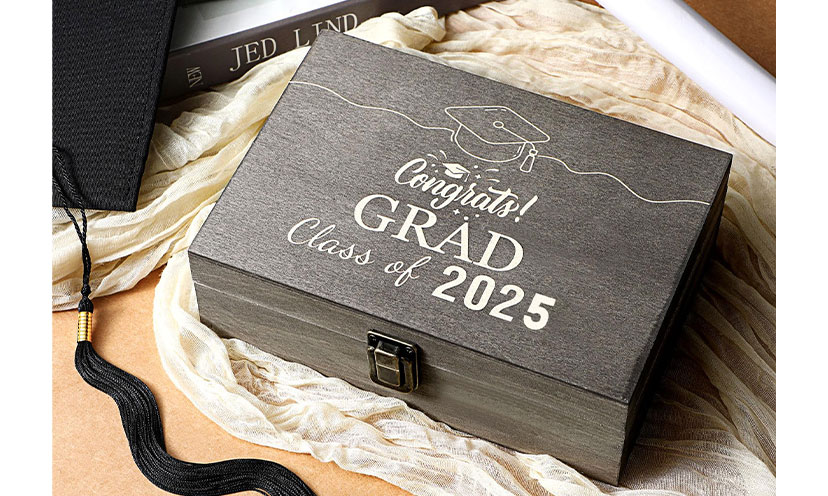 A wooden box with words painted on top "Congrats! Grad Class of 2025"