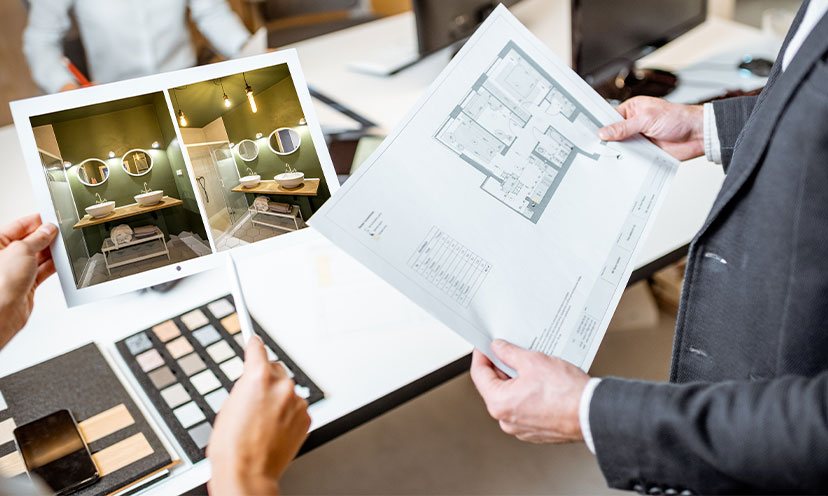 Someone showing someone design plans and pictures